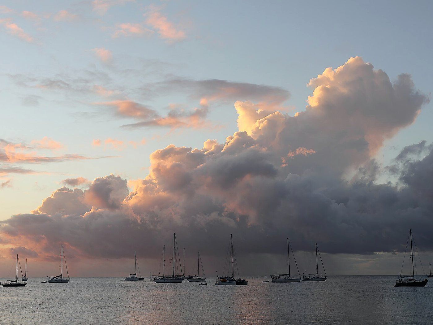 Yachts lying at anchor under an evening sky